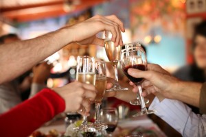 Celebration. Hands holding the glasses of champagne and wine making a toast.