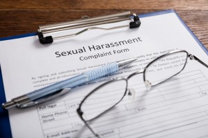 Close-up Of Sexual Harassment Complaint Form With Pen At Desk